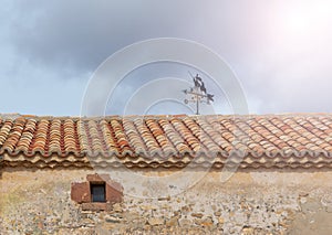 Low angle shot of roof tile on dark cloudy sky background in Soria, Spain photo