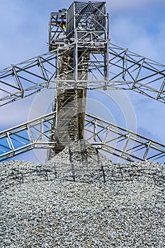 Low angle shot of a rump ejecting crushed stones in a mining site in South Africa photo