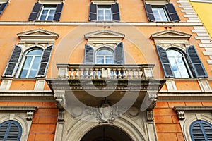 Low angle shot showing details of European classic building with beautiful Italian architectural style window panels