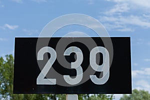 A low angle shot of a signpost with 239 number on it