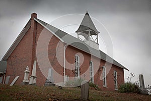 Low angle shot of a small brick church against a cloudy sky near Morgantown, West Virginia
