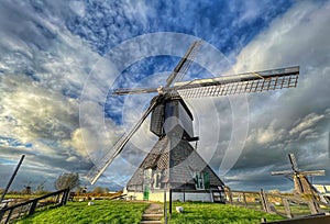 Low angle shot of a spinning historic windmill in Kinderdijk, Netherlands