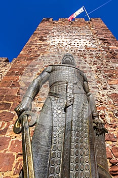 Low angle shot of a statue of King Sancho I of Portugal at the entrance of Silves Castle