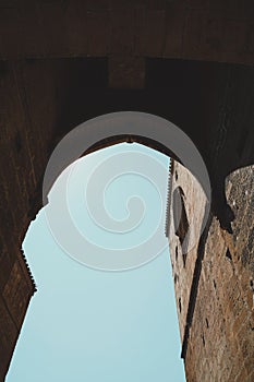 Low angle shot of a stone arch on an old building in vertical