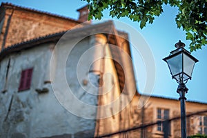 Low angle shot of a street lamp in front of a building with a blurred background
