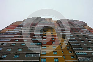 Low angle shot of a tall, colorful, modern apartment building