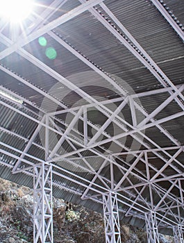 Low angle shot of a tin shed with iron frames and beautiful sun flares from top