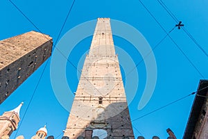 Low angle shot of the tower of Torre Garisenda in Bologna photo