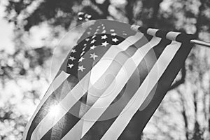 Low angle shot of united states flag with blurred background in black and white