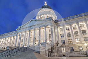 Low-angle shot of the Utah State Capitol Building against the blue sky in the evening