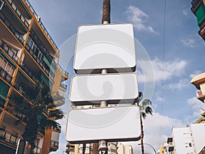 Low angle shot of white blank billboards on the street