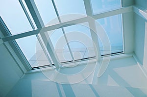 Low-angle shot of a white rooftop window of a house