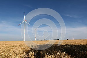 Low angle shot of wind turbines in a field