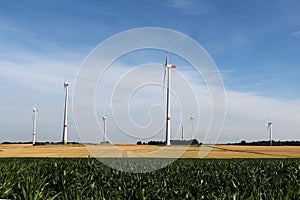 Low angle shot of wind turbines in a field