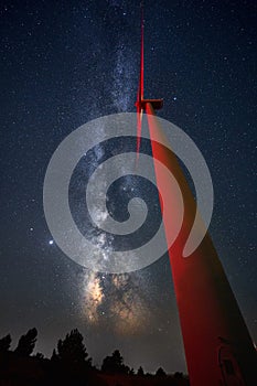 Low angle shot of a windmill and a beautiful milky way galaxy on a night sky