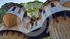 Low angle shot of a wooden castle against green trees in Birr Playground, County Offaly, Ireland