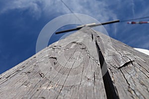 Low angle shot of a wooden cross under a bright sky