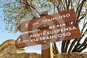 Low angle shot of wooden direction hiking signs in the countryside of Arouca, Portugal