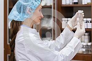 Woman chemist during experimental work photo