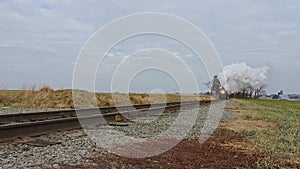 Low Angle of a Steam Passenger Locomotive Approaching on a Single RR Track, on a Winter\'s Day