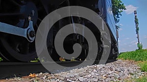 Low Angle of a Steam Passenger Train Rumbling By Blowing Smoke