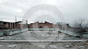 Low angle view of abandoned empty swimming pool with decayed concrete. Apocalyptic urban scene