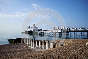 A low angle view across the pebbles towards the Victorian pier