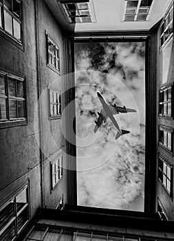 Low angle view of air plane flying over buildings