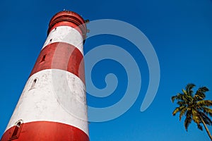 Low angle view of Alleppey Lighthouse with red and white stripes, Aleppuzha, Kerala, India