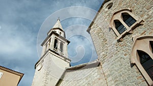 Low angle view of an ancient church and blue cloudy sky. Creative. Concept of religion and architecture.
