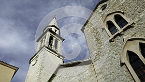 Low angle view of an ancient church and blue cloudy sky. Creative. Concept of religion and architecture.