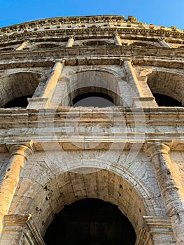 Low angle view of arches and columns exterior of the Colosseum, Rome