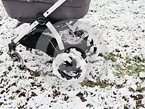 Low angle view of baby stroller carriage with bassinet in the snow field with