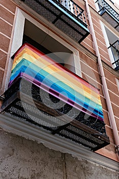 Low angle view of balcony with rainbow flag in Chueca neighbourhood in Madrid photo