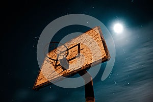 Low angle view of a basketball hoop against starry sky at night