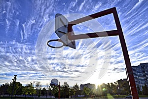 Low angle view of the basketball hoop with a blue sky background
