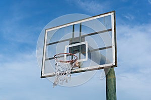 Low angle view of basketball ring on sky background. Outdoor basketball hoop
