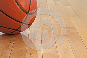 Low angle view of basketball on wooden gym floor