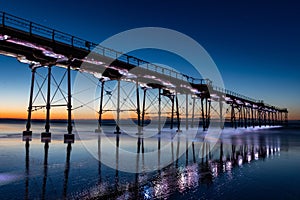 Low-angle view of a beautiful bridge above the sea at sunset in Saltburn, England