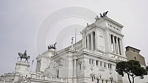 Low angle view of a beautiful building with sculptures of horses on its roof. Action. Concept of classic architecture.