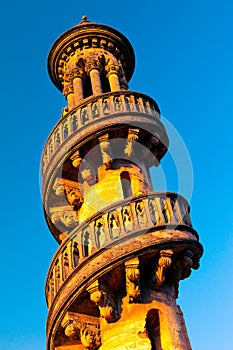 Low angle view of beautiful towering minaret with winding staircase in Mahabat Maqbara Palace in Junagadh photo