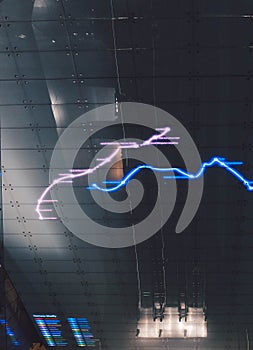 Low angle view of a black roof with pink and blue laser lines on it photo