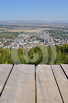 Boardwalk with aerial city view, vertical