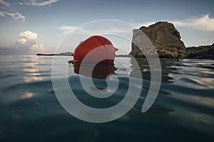 Low angle view of bouy near sea rocks