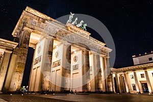 Low angle view of the Brandenburg Gate in Berlin at night with stars in sky