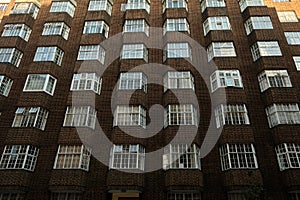 Low angle view of brick wall building facade with windows