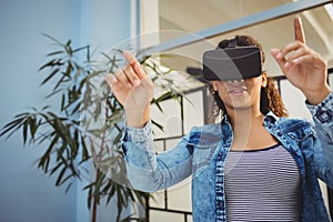 Low angle view of businesswoman enjoying augmented reality headset at office