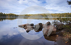 Low angle view of a calm lake with rocks in northern Minnesota on a beautiful autumn day