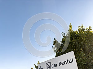 Low angle view of Car Rental sign with car and key pictogram as