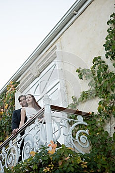 Low angle view of couple embracing while standing in balcony